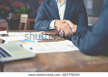 Business partnership marketing meeting concept. Image businessmans handshake. Successful businessmen handshaking after good deal.vintage color, Discussing Together Startup Idea.Working Online Project Royalty-Free Stock Photo #683798263