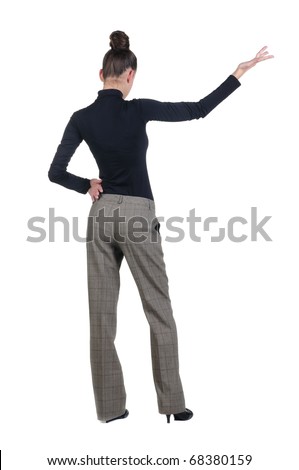 Back view of beautiful young business woman pointing at wall. Rear view. Isolated over white background.