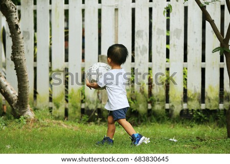 Asian boy hold ball in the park, Boy playing football