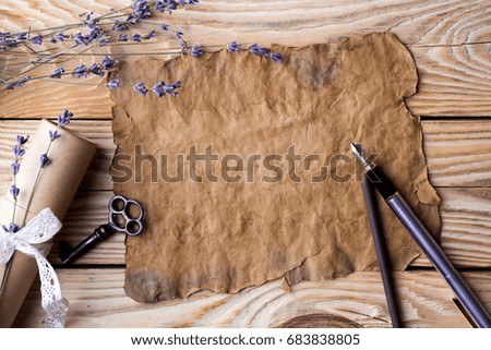 Old paper with lavender and gift on the wooden table background. Vintage concept