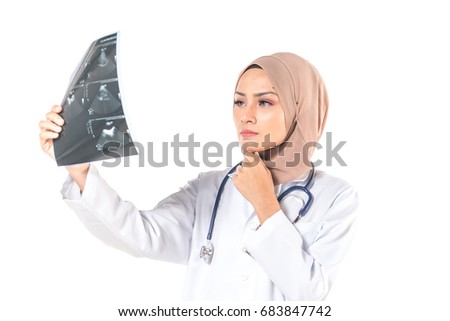 Hijab medical doctor looking at x-ray picture