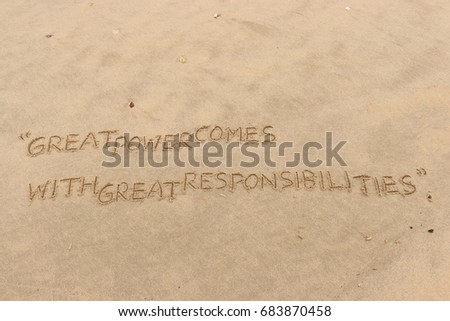 Handwriting  words "GREAT POWER COMES WITH GREAT RESPONSIBILITIES" on sand of beach. Royalty-Free Stock Photo #683870458