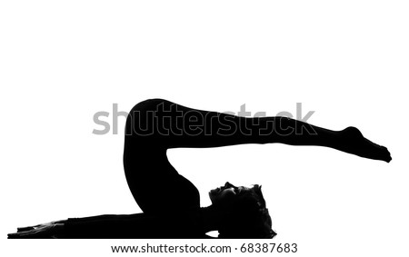 woman exercising lying on back fitness yoga stretching in shadow grayscale silhouette full length in studio isolated white backgroun