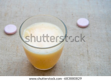 Effervescent tablet (vitamin) in a glass of water.