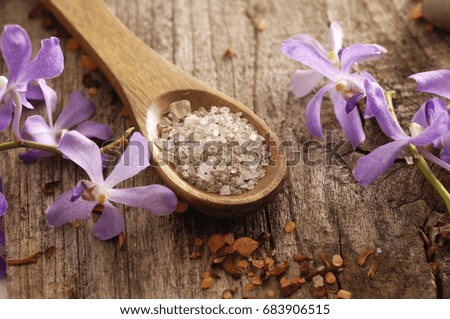Orchid and dry flower petals orchid,salt in spoon  on old wood