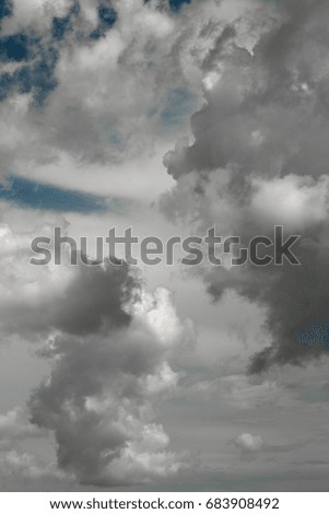 White clouds in the sky making abstract shapes; 