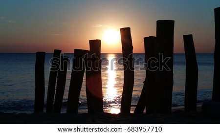Sunset beach between poles