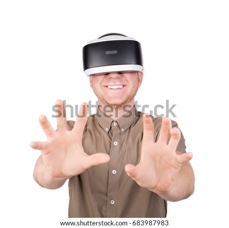 3d vision technology, video game simulation. Male action in virtual reality helmet, isolated on a white background. A guy trying to touch or embrace with hands virtual objects in a digital simulation.