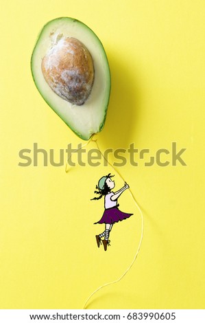 Drawing girl fly with balloon made of avocado fruit on the yellow background                        