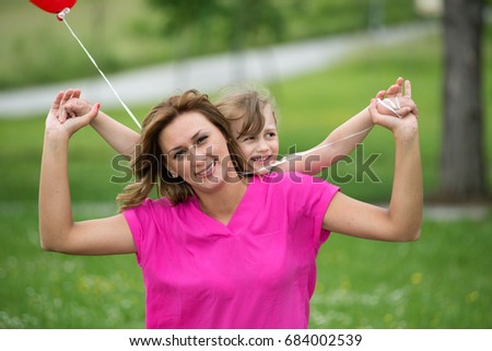 Mother and daughter playing in park