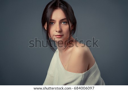 Young woman casual studio portrait in white top with copy space