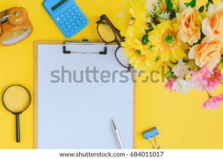 Office equipment on a yellow and golden paper desk with a business workspeac and color vivid