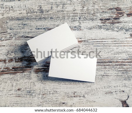 Blank white business cards on vintage wooden background. Template for ID with plenty of copy space.