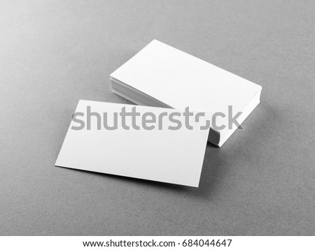 Photo of blank business cards on gray paper background. Template for branding identity. Mockup for ID. Studio shot.