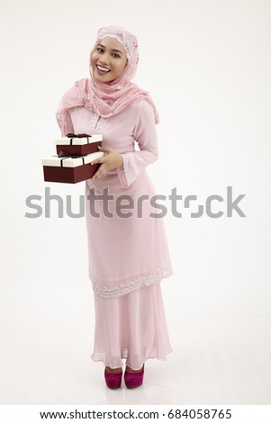 malay woman with tudung holding a present