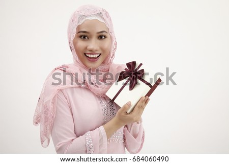 malay woman with tudung holding a present