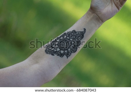 Woman Hands with black mehndi tattoo