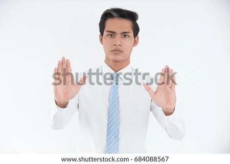 Portrait of young manager showing stop gesture