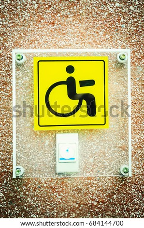Yellow sign and call ring for the disabled.