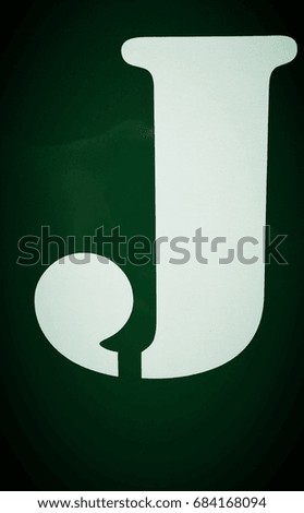 Capital J letter on green background
