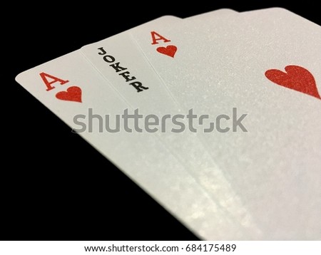 Blur picture of Playing Cards-two aces and one joker isolated on black background