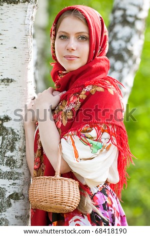 girl with a basket near the birch forest