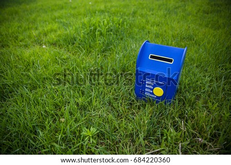 Blue mailbox on the grass
