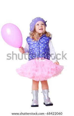 Cute little girl in pink pettiskirt ind violet vest with balloon