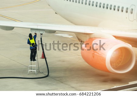 Refueling of the aircraft at the airport Royalty-Free Stock Photo #684221206