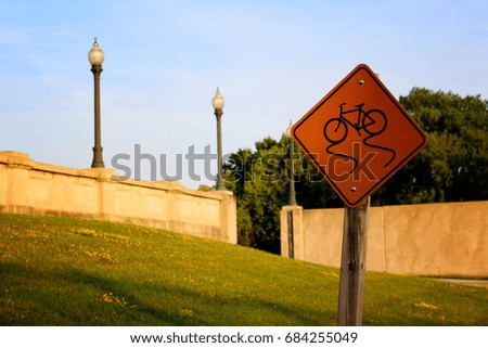 bicycle sign outdoors with trees and blue skies