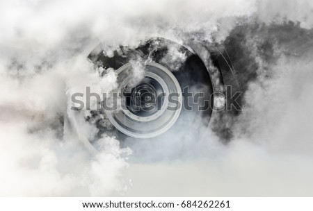 Drag racing car burns rubber off its tires in preparation for the race Royalty-Free Stock Photo #684262261
