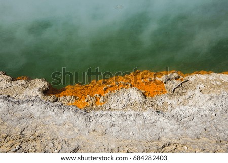 A picture of the edge of a hot spring Champagne Pool with smoke rising at Wai-O-Tapu Thermal Wonderland.