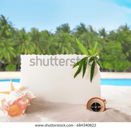 Blank card with sea shell and compass on beach. Summer vacation concept