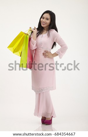 malay woman with baju kurung shopping for raya