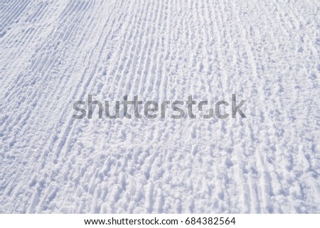 Winter picture. The texture of the trampled snow on the ski track. Bright abstract background ideal for any design
