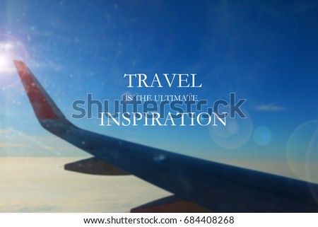 Blurry aircraft wing against blue sky with Inspirational quote - Travel is the ultimate inspiration