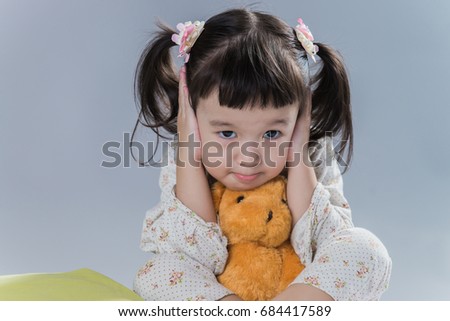 Cute little girl wear pajamas and play in gray background. Easy for di cut.