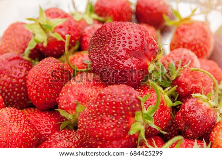 The horizontal frame.y red strawberries, on blurred background taken close-up, selective focus. The horizontal frame.