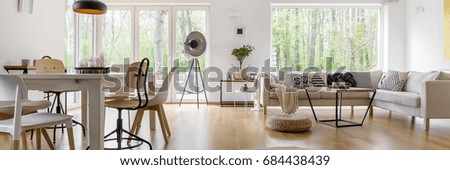 Spacious cozy living room with big windows and glass door Royalty-Free Stock Photo #684438439