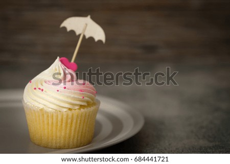 Cupcakes are beautifully decorated in Dark lighting