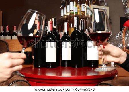 Couple tasting wine at store, closeup Royalty-Free Stock Photo #684465373