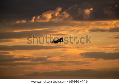 Airplane taking off with clouds in the sky