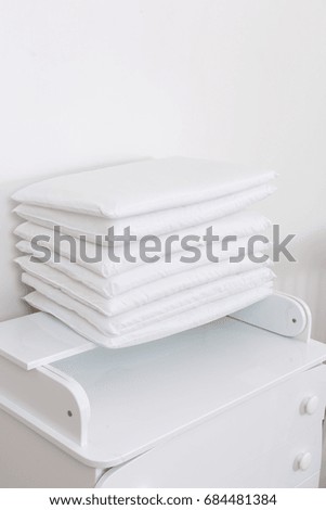 Pillows white. Blank soft pillows On a white chest of drawers