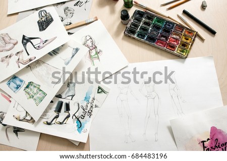 Fashion sketches on desiner desk. Art watercolor illustration of clothing creations