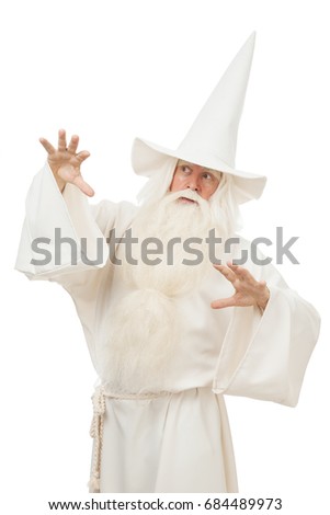 A man in a sorceress costume and wearing a hat on a white background