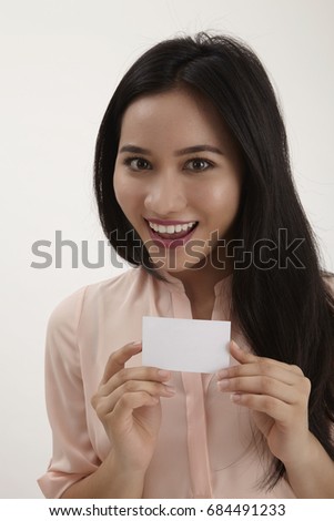 woman showing empty blank paper card sign with copy space for text. female model isolated on white background.