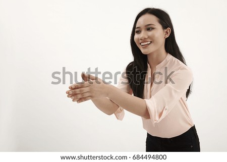malay woman raising arm about to do hand shake
