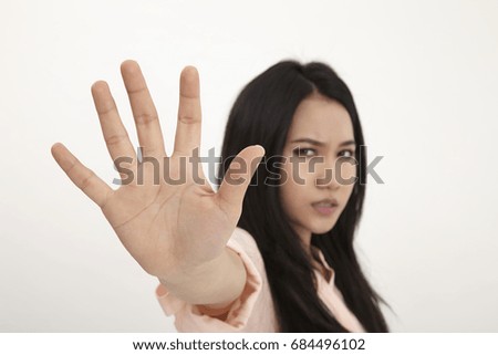 Malay woman making stop sign on white background,focus on the palm