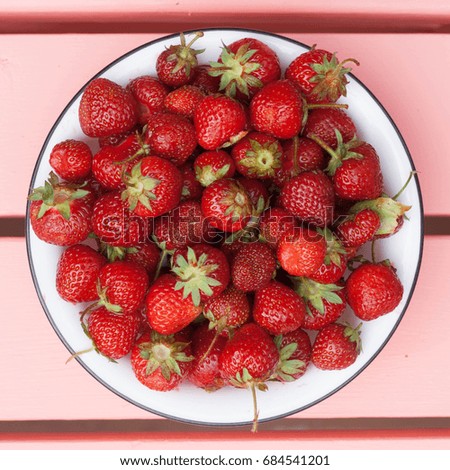 Wild strawberries in a bowl square image