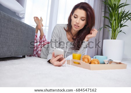 Beautiful happy woman having breakfast in bed
